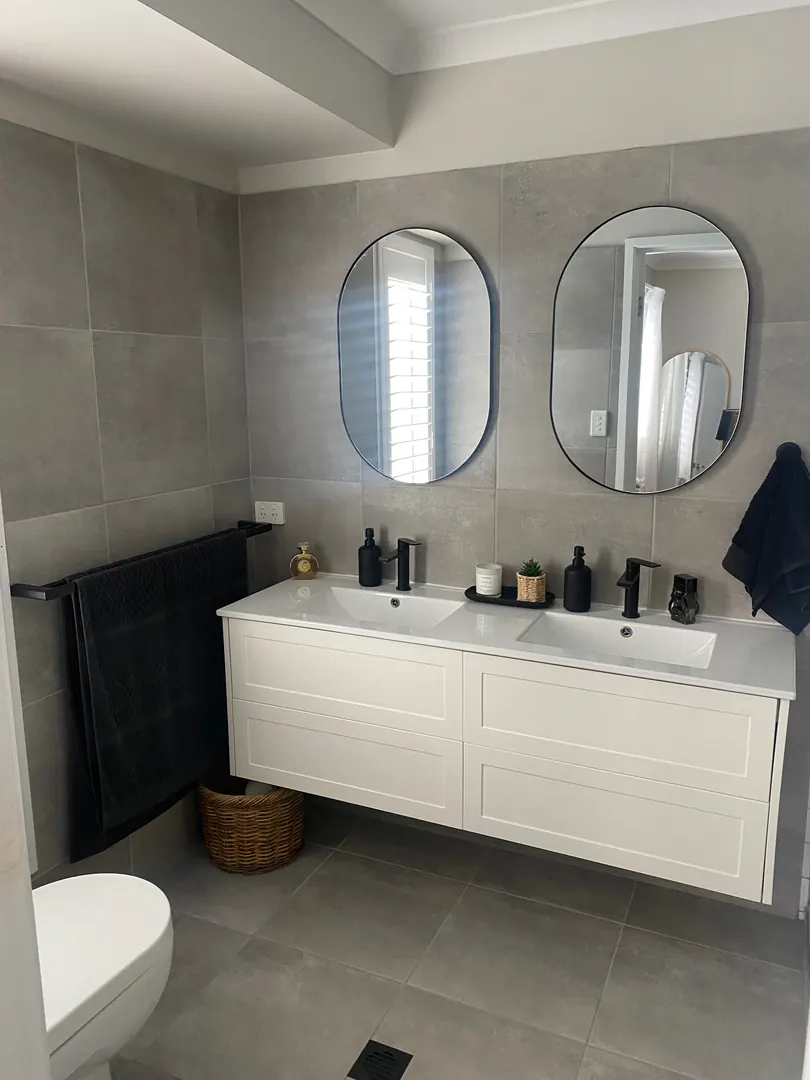 Completed Gold Coast bathroom renovation with double vanity and full-height tiling